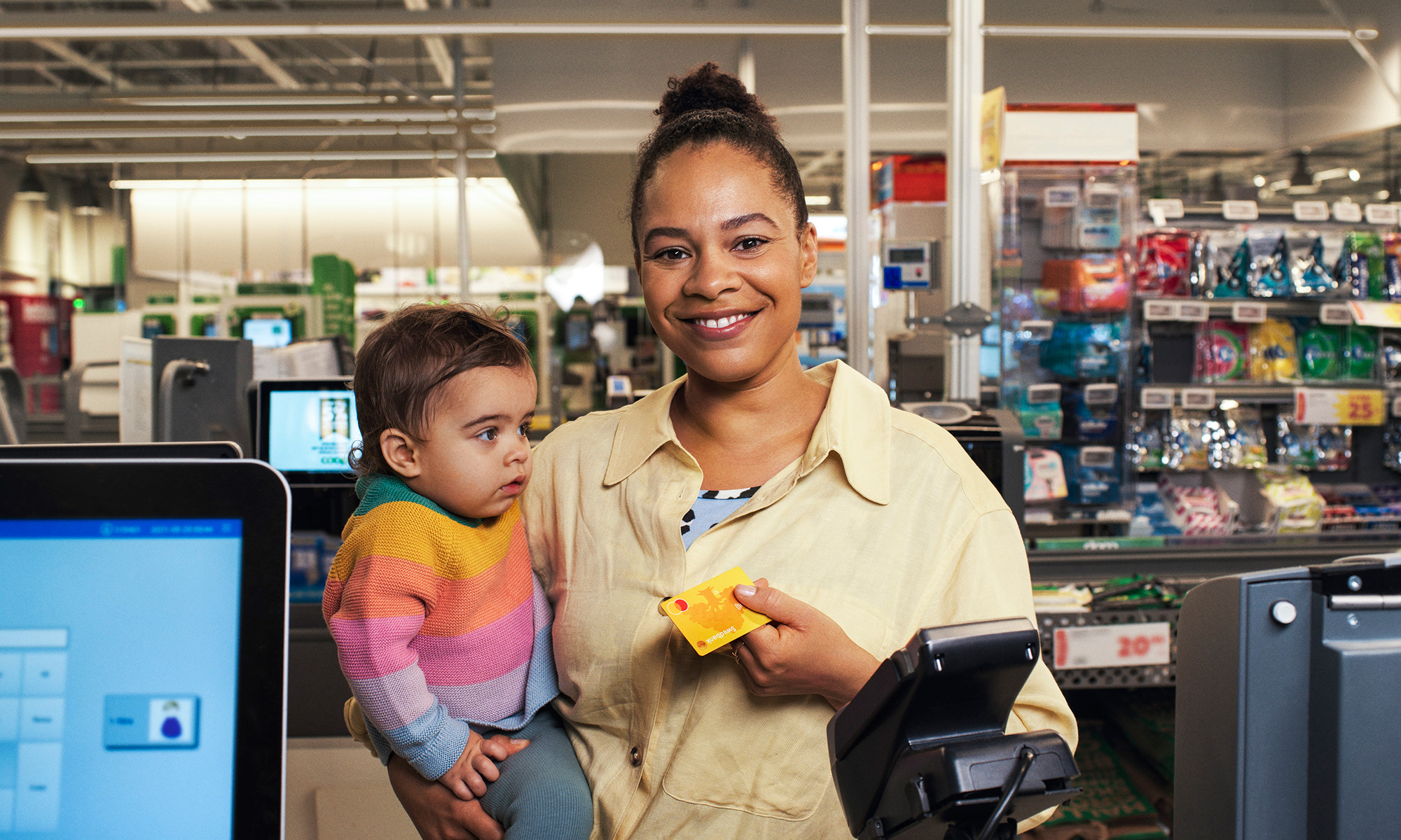 Woman and her child paying in grocery store